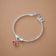 A silver bracelet with a charm in the shape of a car, designed for children.